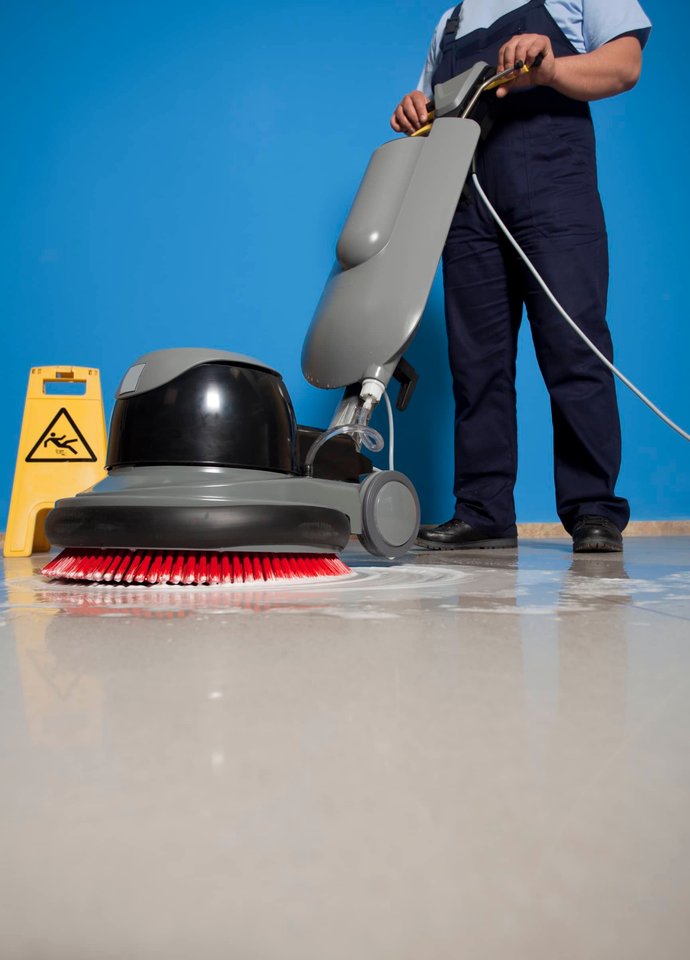 Commercial floor being scrubbed in a tiled lobby.