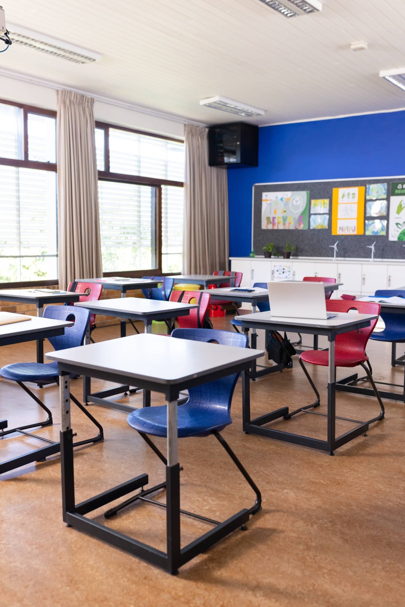 Empty modern classroom with desks.