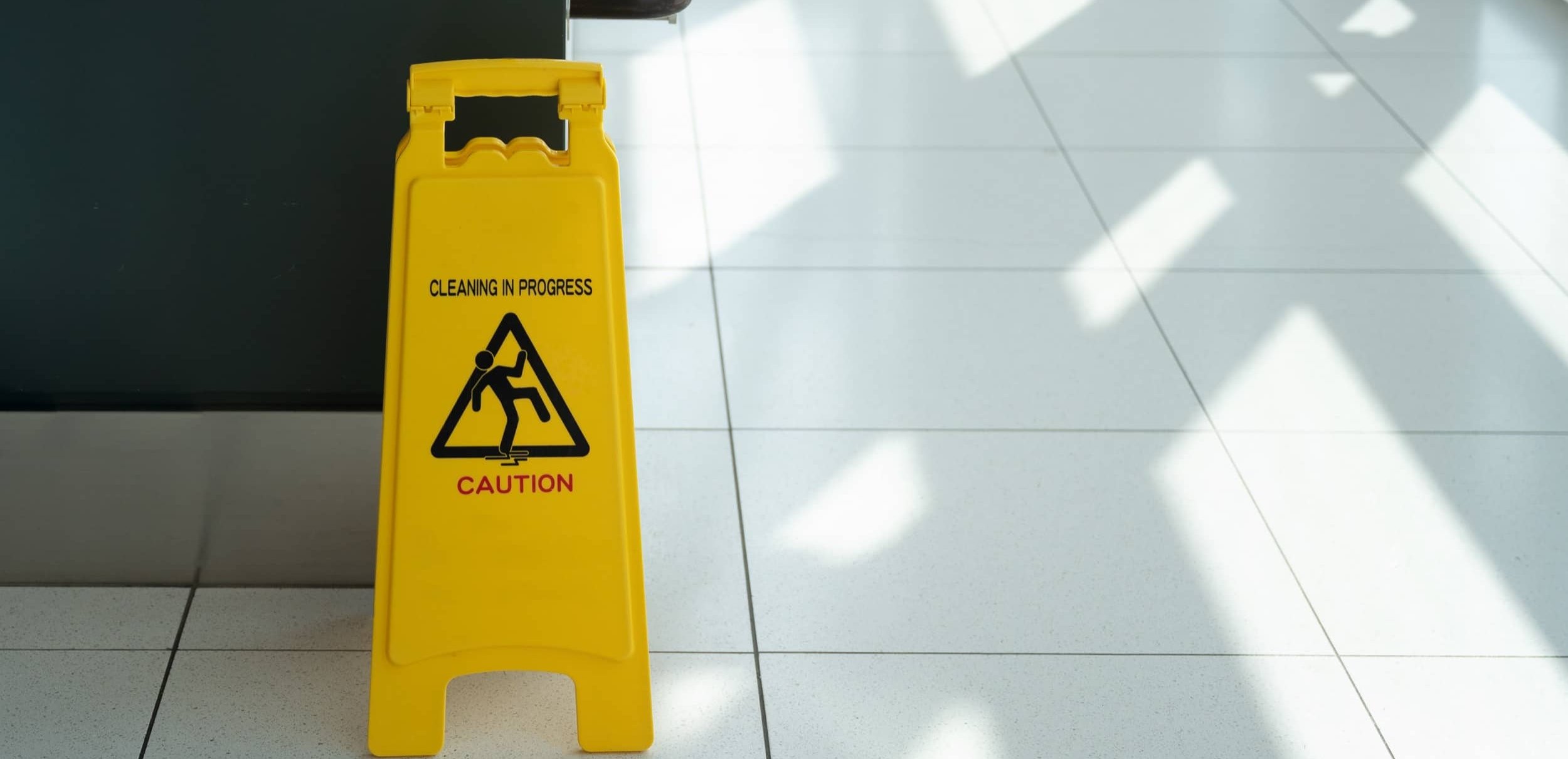 Safety sign on a freshly cleaned commercial corridor.