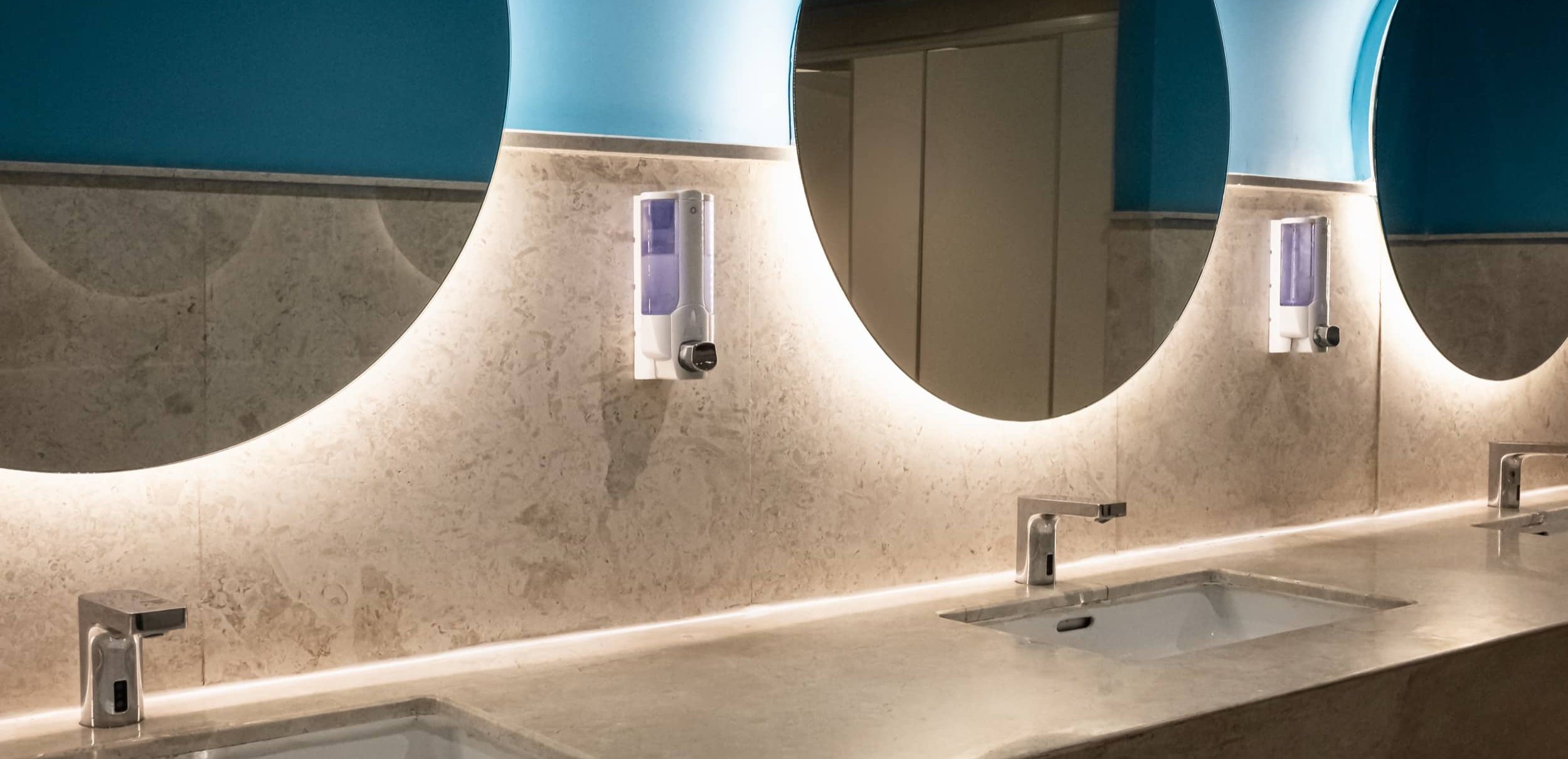 Clean, well-stocked commercial washroom.
